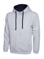 Light grey pullover hoodie with a navy blue hood lining and drawstring, long sleeves, and a front kangaroo pocket.