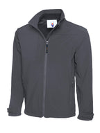 Dark gray softshell jacket with a high collar, full-zip front, chest pocket, and adjustable velcro cuffs.