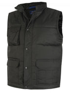 Black quilted utility vest with a high collar, snap-button placket, and multiple front flap pockets. Regular fit.