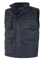 Navy blue quilted vest with stand collar, zip-front, snap storm flap, and multiple utility pockets. Regular fit.