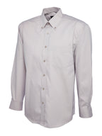 Light grey, long-sleeve, button-down dress shirt with a pointed collar, chest pocket, and relaxed fit.