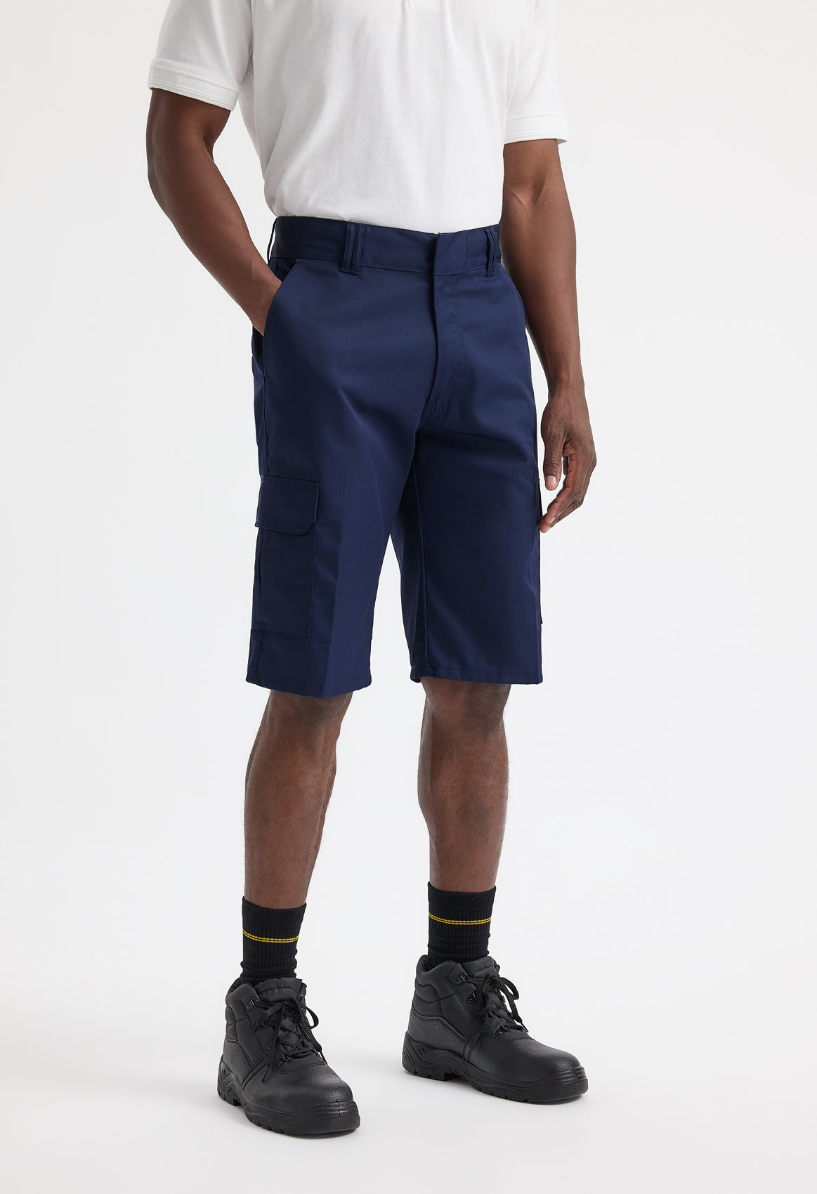 Person wearing navy shorts and black shoes on a white background